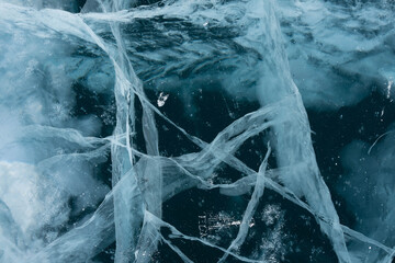 thin cracks of ice in a transparent lake