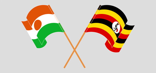 Crossed and waving flags of Niger and Uganda