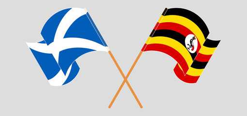 Crossed and waving flags of Scotland and Uganda