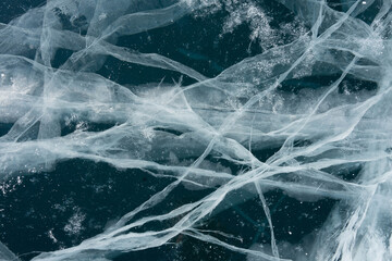 thin cracks of ice in a transparent lake