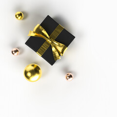 black gift box with golden ribbon and gold christmas balls on the white background, luxury festive 3D illustration, square graphic design for marketing, white copy space, top view