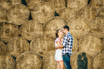 a guy with a girl on a summer walk in the field