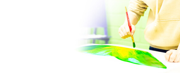 a person draws with a brush and paints on a large canvas in an art studio. creative, modern artist of fine art, a masterpiece of drawing, drawing training, art school, distance drawing courses, banner