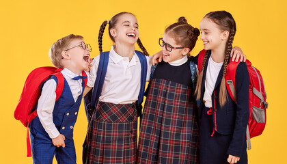 Cheerful youngsters in school uniform laughing together