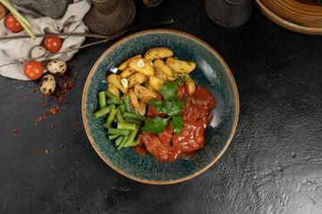 Beef with baked potato slices with garlic and rye beans