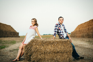 a guy with a girl on a summer walk in the field