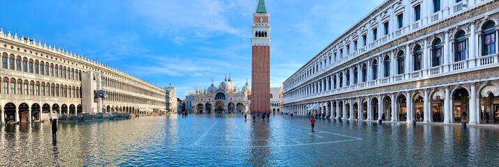 Flooded St. Mark's Square, Piazza San Marco in Venice, Italy. On sides the amazing architecture with arches. Absalutely gorges place