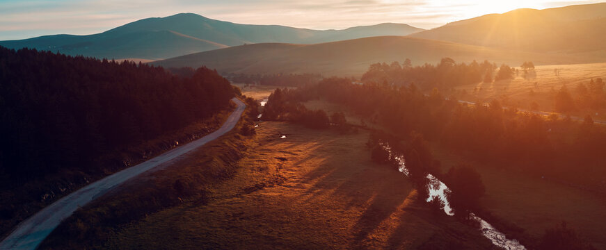 Beautiful sunrise at Zlatibor Vodice region, sunlight over white pines and valley creek