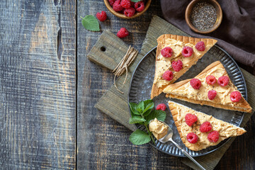 Fototapeta na wymiar Summer sweet dessert sandwich breakfast. Tasty toasted with peanut butter and raspberry on a rustic wooden table. Top view flat lay background. Copy space.
