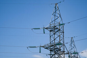 Power lines and high voltage towers in the field