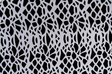 A white metal pattern on a black background
