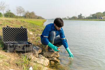Technician use the Professional Water Testing equipment to measure the water quality at the public canal. Water quality monitoring concept.