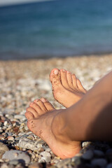 feet in sand, summer beach and beautiful sunburn legs by the sea