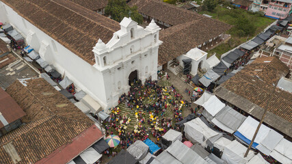 
Side aerial view of the church of Chichicastenango Guatemala, sale of flowers and people at the...