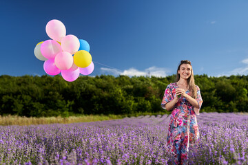 Woman with balloons in a lavender field