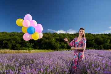 Woman with balloons in a lavender field