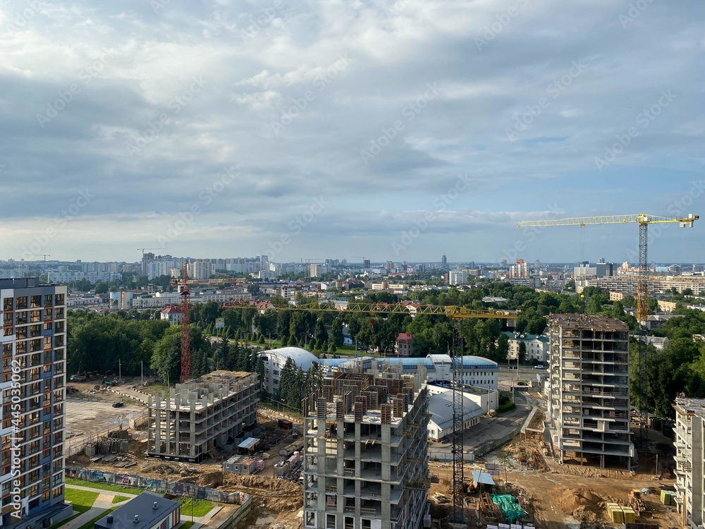 Poster a view from a height of a large modern construction site of tall large houses and multi-storey build