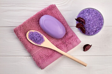 Flat lay natural purple salt with soap and towel.