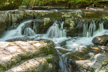 Fototapeta na wymiar Long exposure of a waterfall on the East Lyn river at Watersmeet In Exmoor National Park