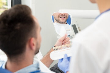 Man in stomatology clinic. Teeth whitening.