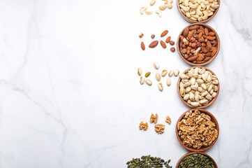 Different kind of nuts in wooden bowls