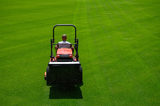 Mowing grass at the football stadium