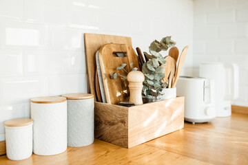 kitchen details, accessories, ceramic jars, wooden table, white ceramic brick wall background....