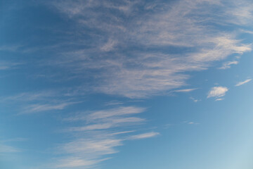 Thin clouds on bright blue sky.