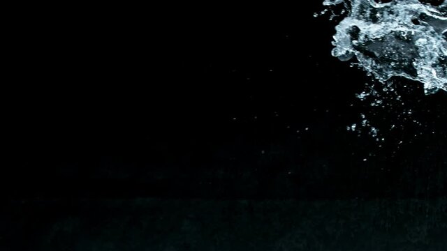 Super slow motion of water splash on black background. Filmed on high speed cinema camera, 1000 fps.