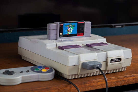 São Paulo, Brazil- 07, 2021: Old video game Super Nintendo with control and television in the background