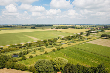 Naklejka premium view of the countryside. Top view of fields and trees next to farms and wind turbines. Landscape in Germany 