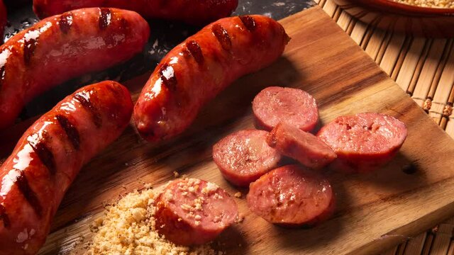 Grilled sausage with smoke. Grilled Sausage on wooden board. Brazilian barbecue.