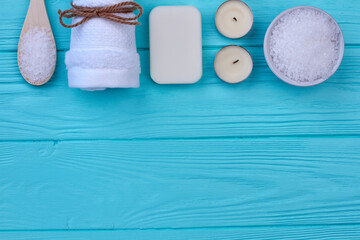 Bath and spa accessories on blue wood and copy space.