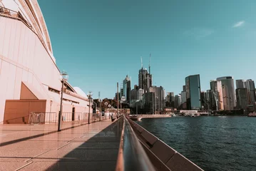 Selbstklebende Fototapeten "Sydney, NSW / Australia - April 17, 2020: Sydney Opera House and Circular Quay surroundings completely isolated and with social distancing under lockdown due to Coronavirus outbreak" © Juan