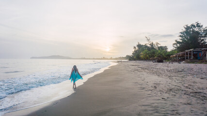 Girl enjoying the beach with a pretty sunrise in Tela Honduras