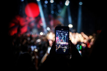 Using a mobile phone at the concert.