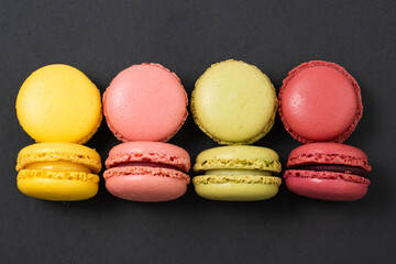 Macarons on dark background, colourful french cookies macarons. 