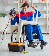 Disabled man repairing chair in workshop