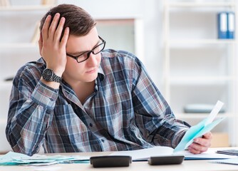 Young man frustrated at his house and tax bills