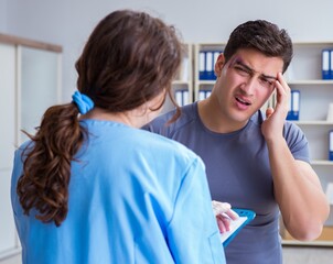 Young man visiting female traumatologist with black eye
