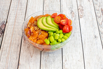 Norwegian salmon poke bowl with Mexican avocado, Japanese edamame and Spanish cherry tomatoes in a...