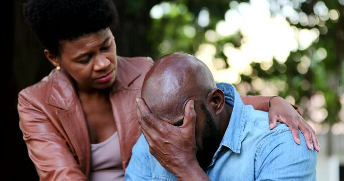 Upset man, woman consoling partner