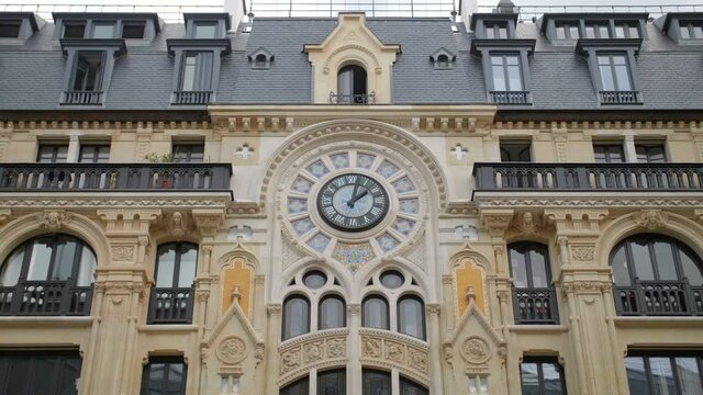 Unique Art Nouveau Facade Of A Building In Rue Reaumur, Paris, France With Ornate Clock On Exterior. Front view.