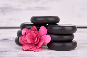 Naklejka na ściany i meble Close-up rose flower head and polished stones for spa.