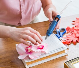 Woman decorating picture frame in scrapbooking concept