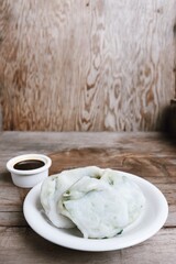 Steam dumplings chives Chinese food on wood table background