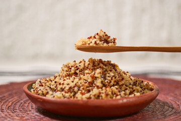 Quinoa cooked in a clay plate. Healthy vegan food concept.