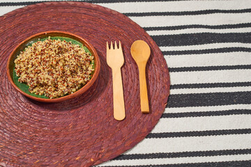 Quinoa cooked in a clay plate. Healthy vegan food concept.