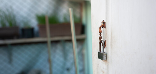 lock is hanging on house's door