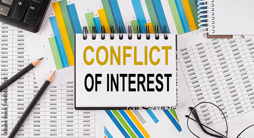 Poster closeup a notebook with text conflict of interest , business concept image on chart background